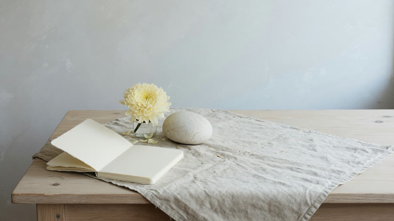 Open blank notebook and cream chrysanthemum