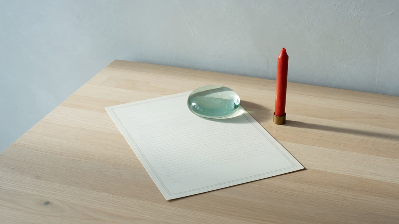 Blank paper under a paperweight